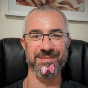 Ilia Frenkel with a small pink bow in his beard